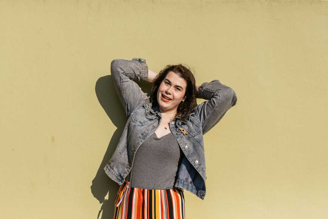 woman in gray button up jacket sitting on chair
